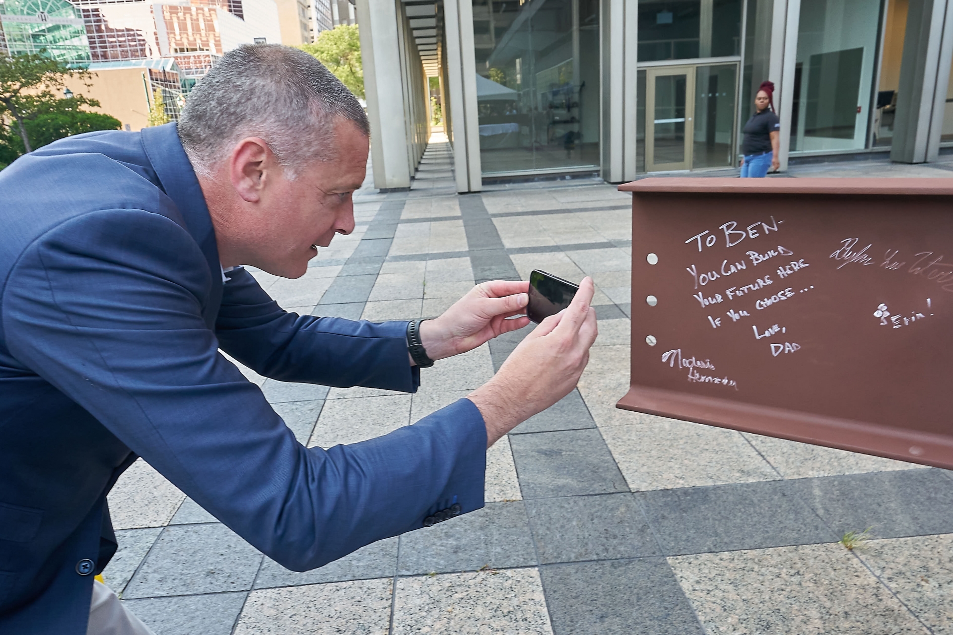 CenterState CEO President Rob Simpson takes a photo of a note he wrote on a steel beam at The Tech Garden Expansion Kickoff. 